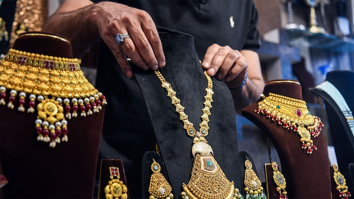 Gold, silver decline up to 2% on hawkish Fed signals ahead of festive buying
